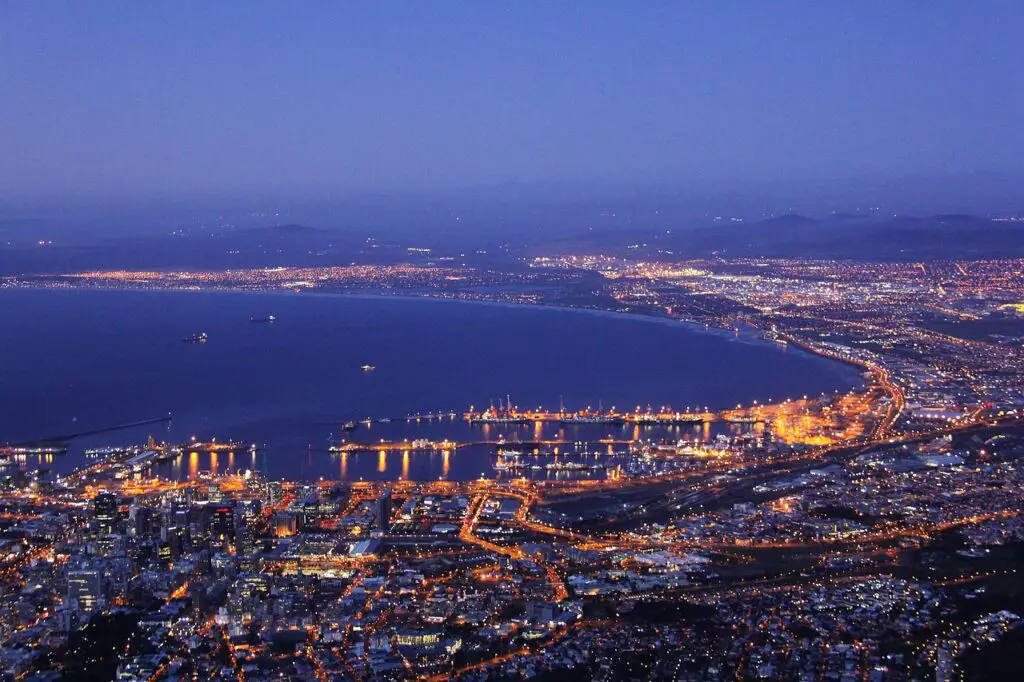 Vibrant reflections in the night: V&A Waterfront, where the city's lights dance on the harbor.