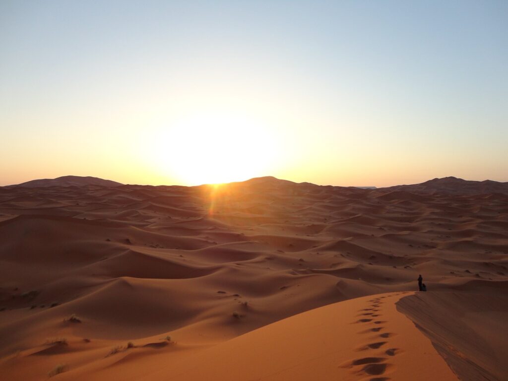 The sun's farewell bathes the desert landscape in warm tones