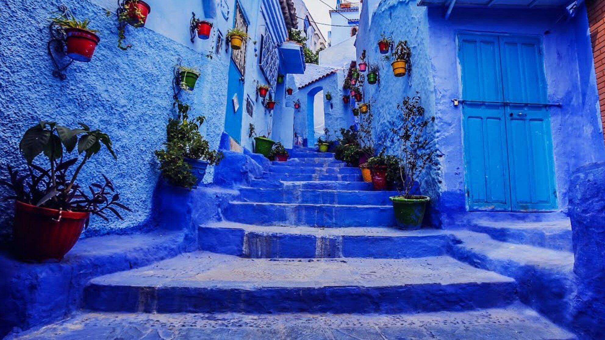  Chefchaouen's enchanting streets, where every corner unveils a canvas of vibrant blue hues.
