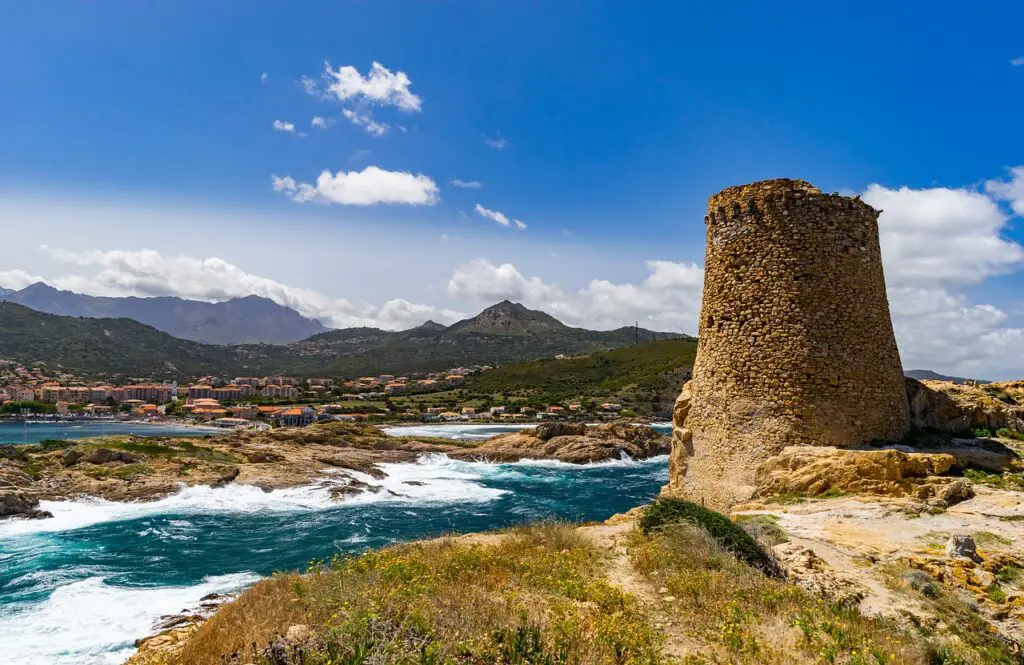 Guarding the pristine Sardinian coast, a historic tower stands tall, bearing witness to centuries of maritime history.